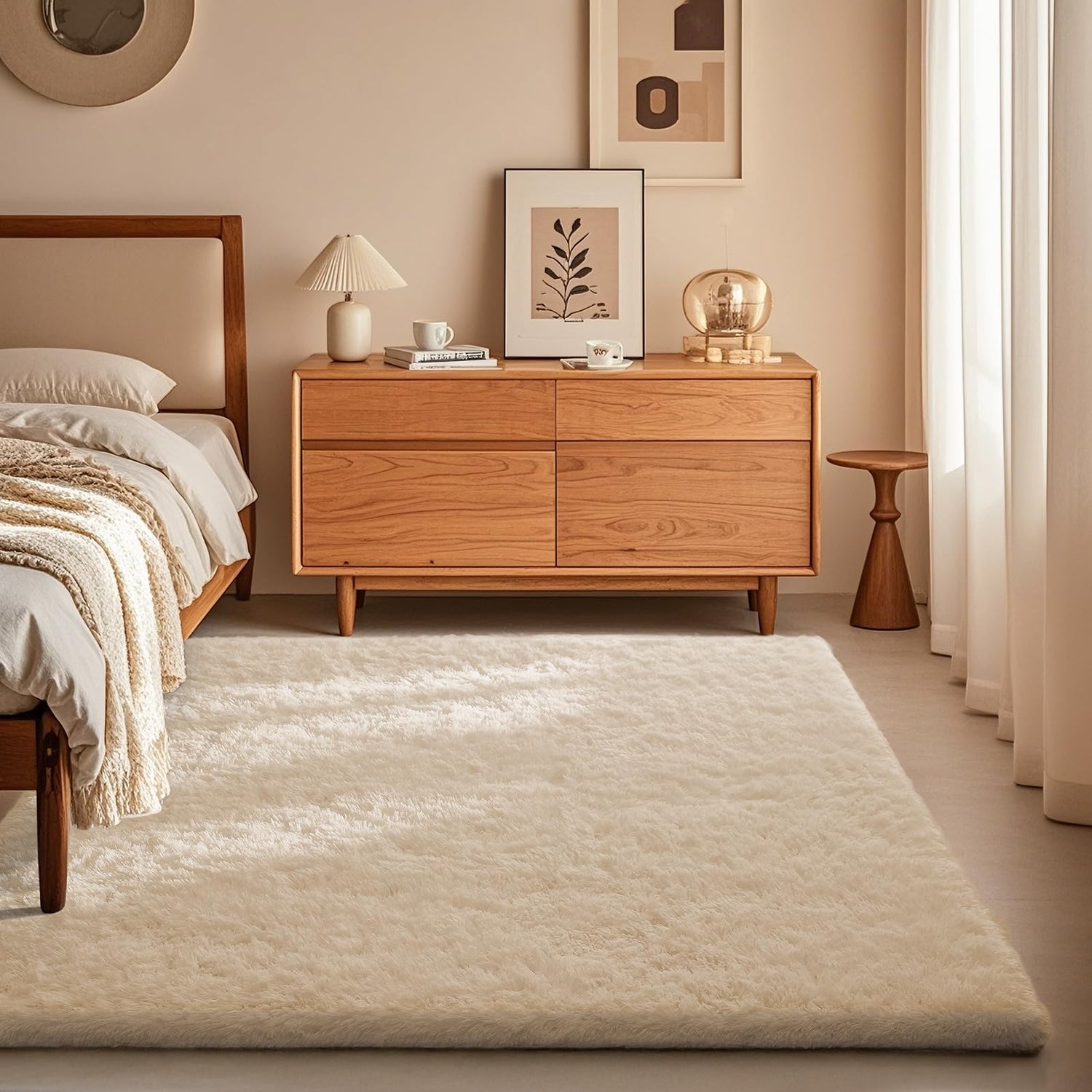 Plush off-white shag rug on floor beside a wooden bed and low dresser in a warm, neutral bedroom.