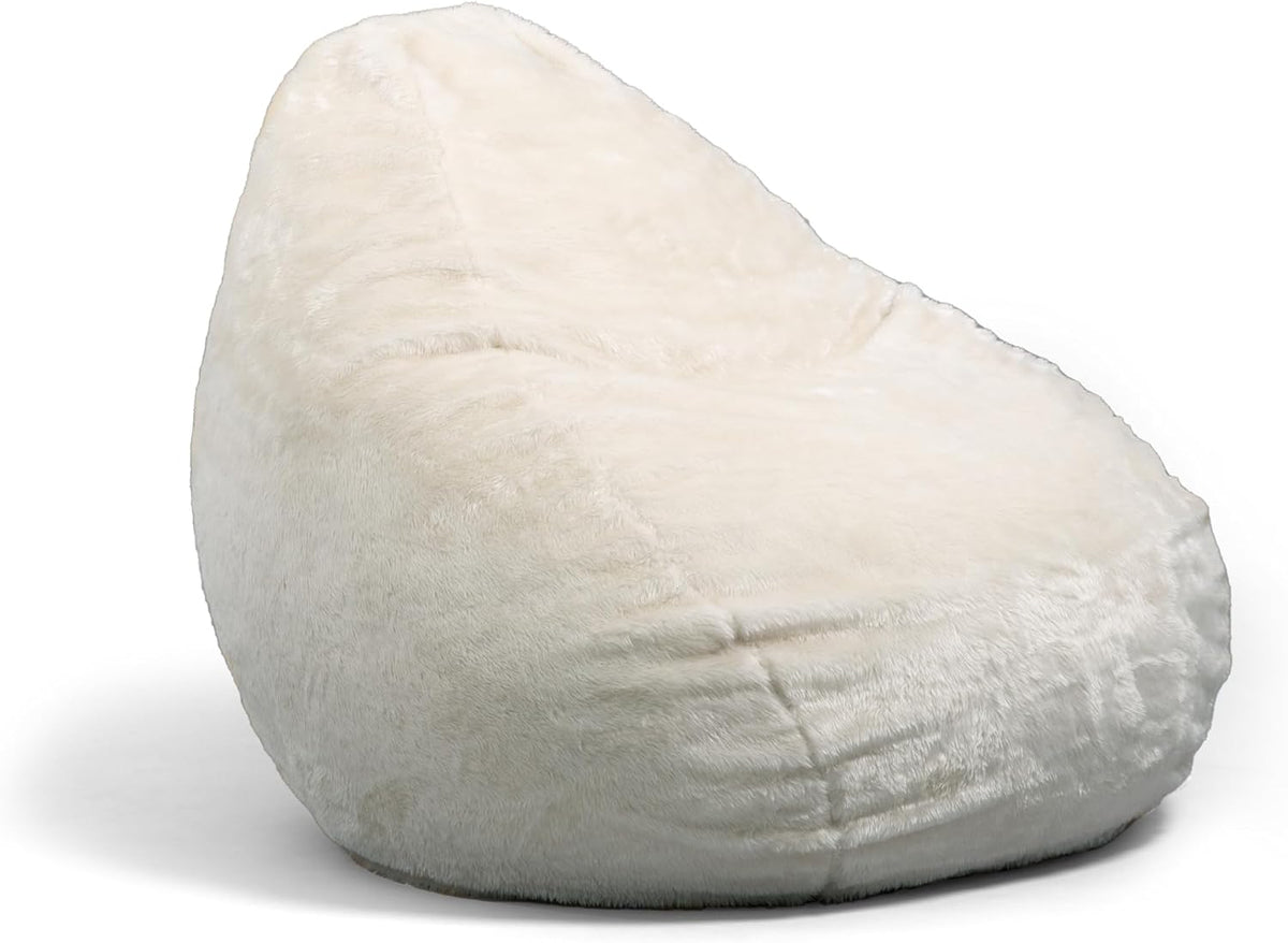 Angled side view of a cream, plush oversized bean bag showing soft fur texture.