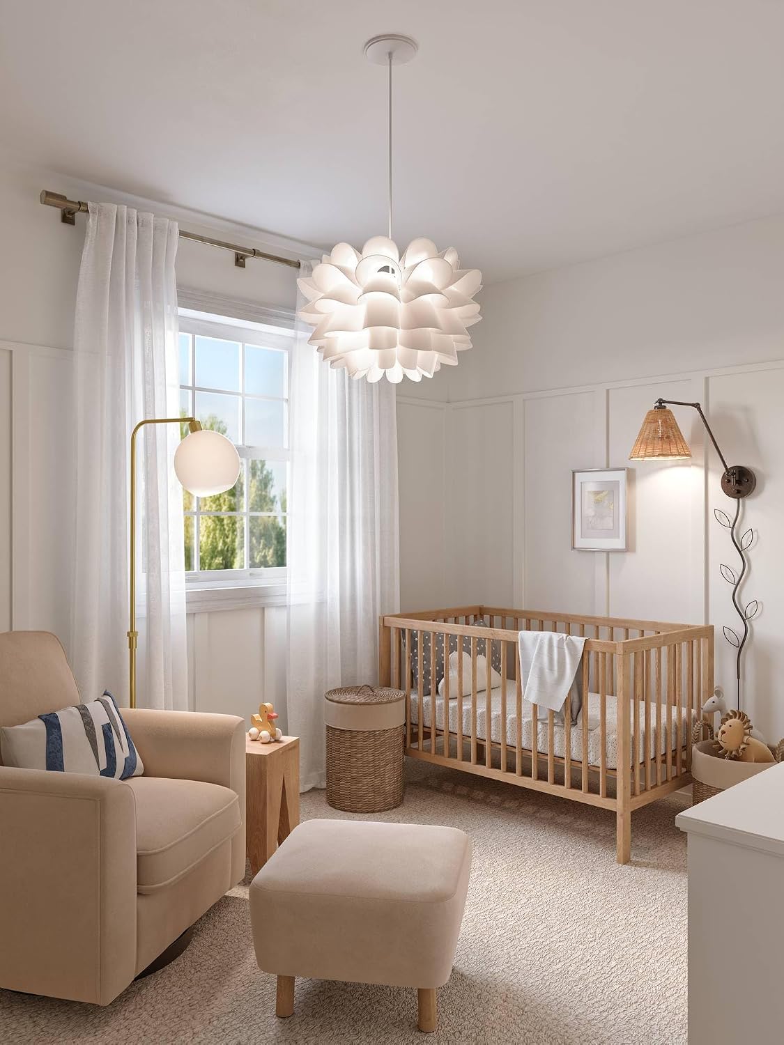 Nursery scene with the pendant above a crib, armchair and ottoman near a sunlit window.
