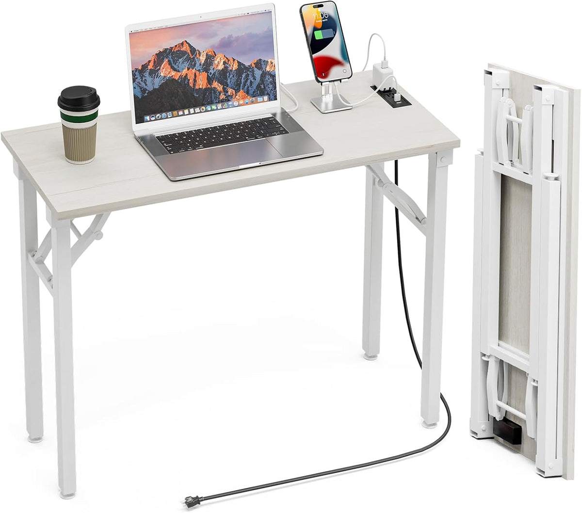 White tabletop desk set up with laptop and phone charger, plus a separate folded white table leaning upright.