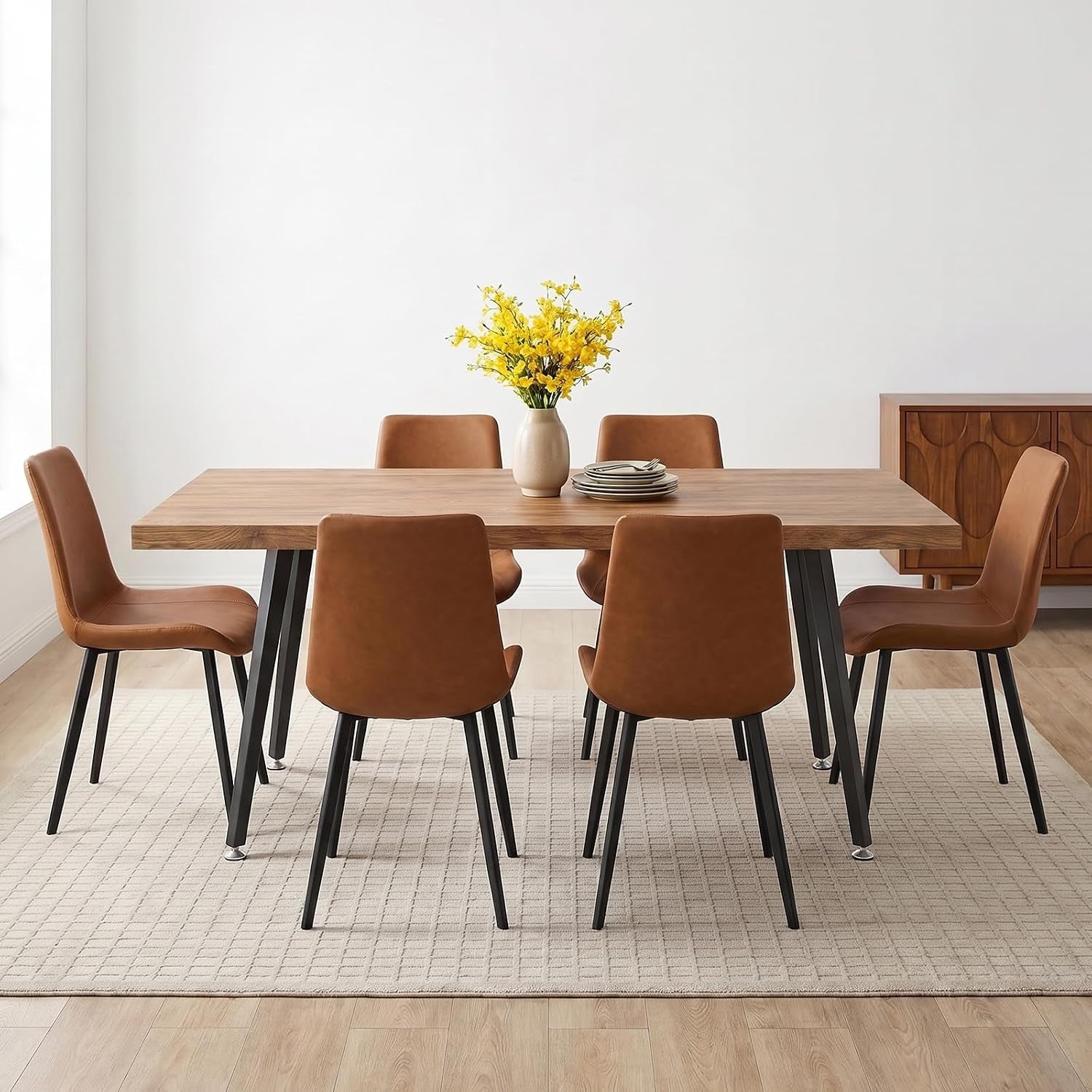 Seven-piece dining set with brown PU chairs around a rectangular wood tabletop in a bright, minimal dining room.