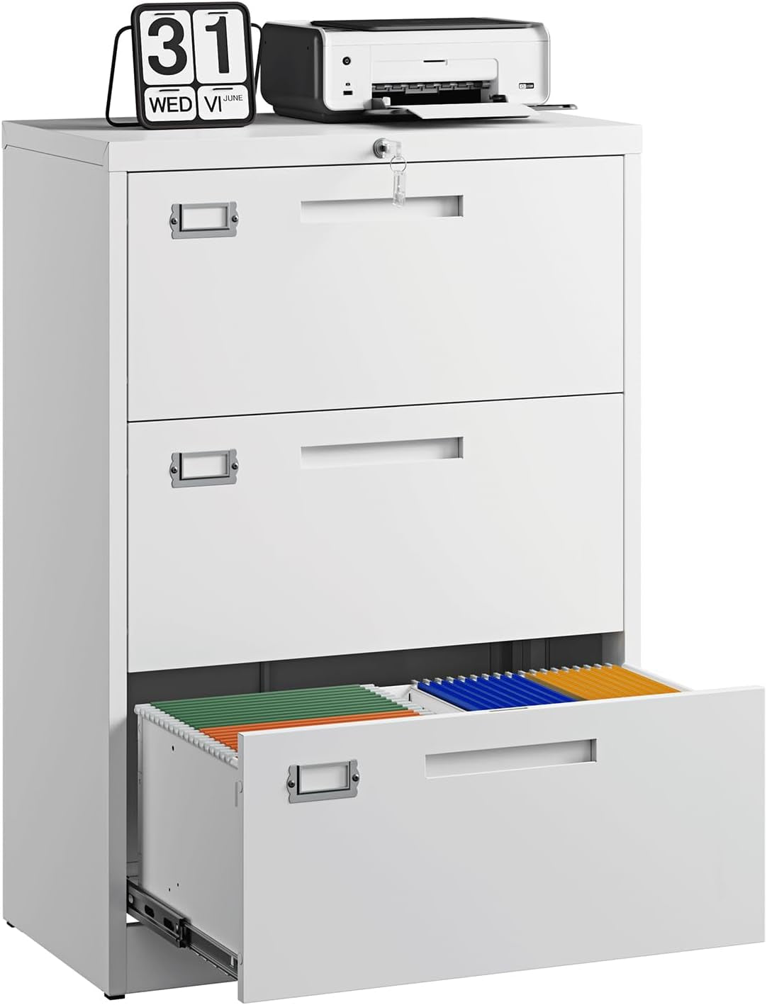 White three-drawer metal filing cabinet with bottom drawer open showing colored hanging files and a printer and calendar on