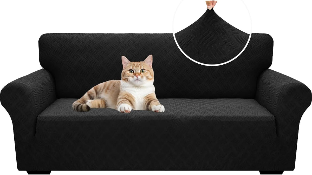 Black three-seat sofa covered in textured slipcover with a ginger-and-white cat on the seat and a circular fabric zoom
