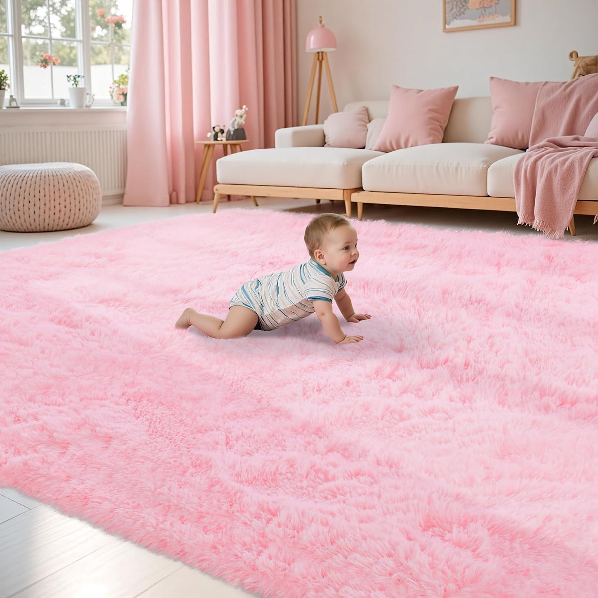 Baby crawling on a large fluffy pink shag rug in a bright living room with a sofa and pouf.