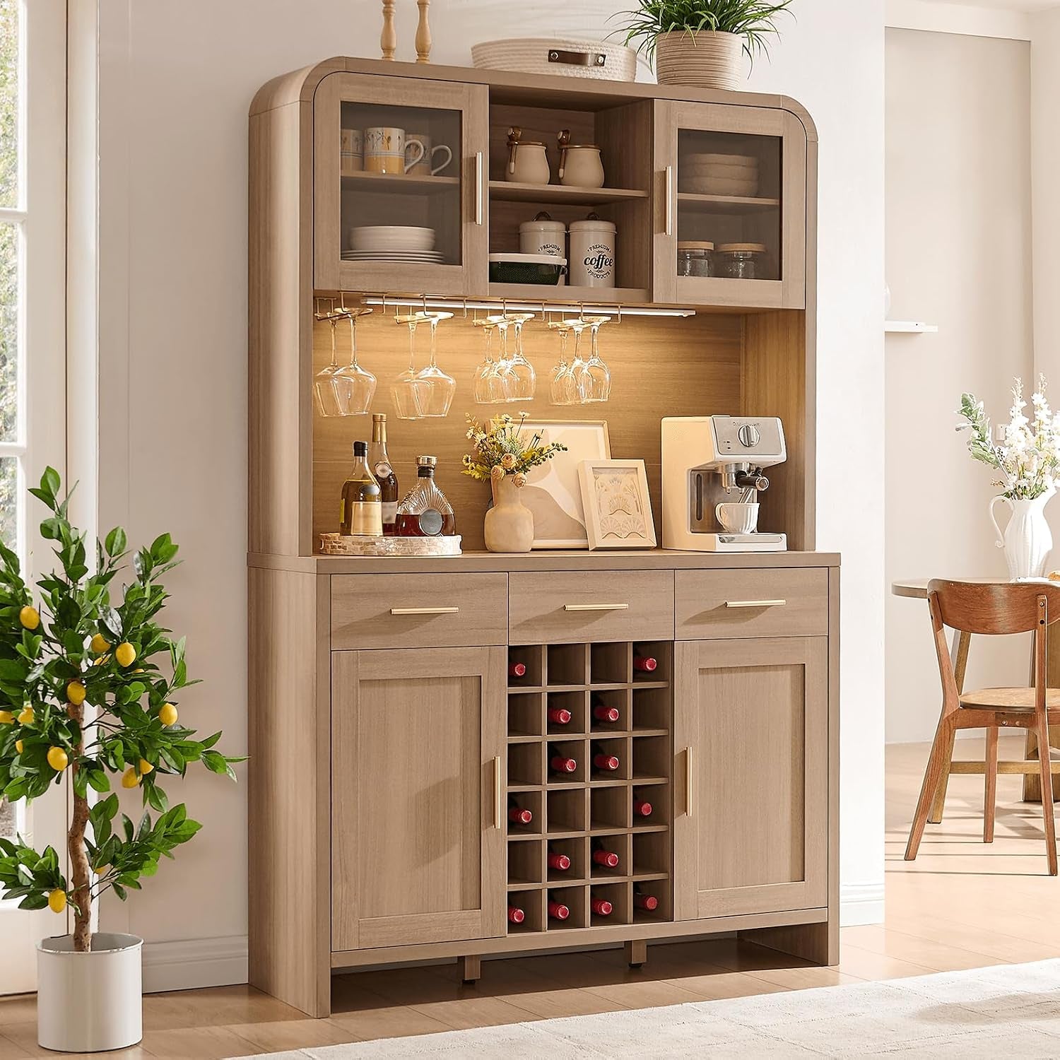 Oak-finish pantry and wine bar cabinet angled front view with countertop coffee maker and hanging wine glasses