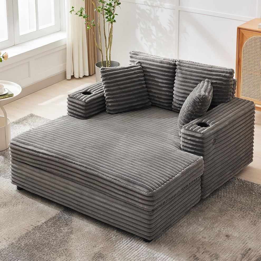 Grey corduroy oversized chaise lounge angled front view showing cup holders and throw pillows