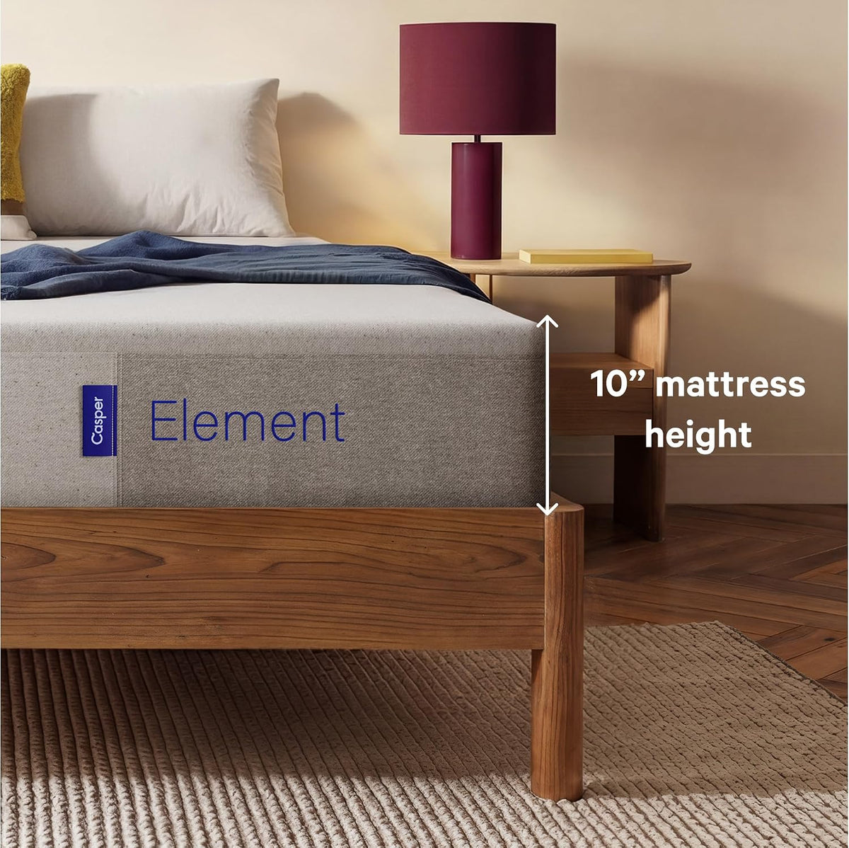 Side view of the mattress beside a nightstand showing a 10-inch mattress height indicator.