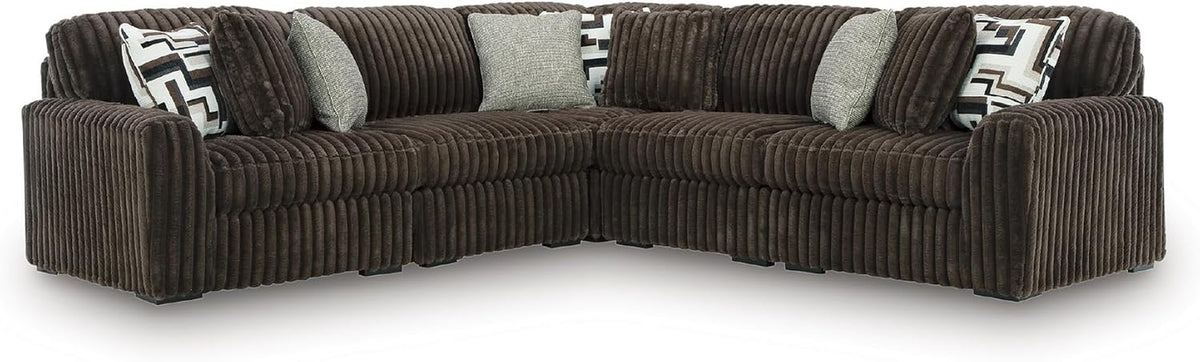 Wide front view of the chocolate brown corduroy sectional showing tufted ribbed cushions and low block feet.