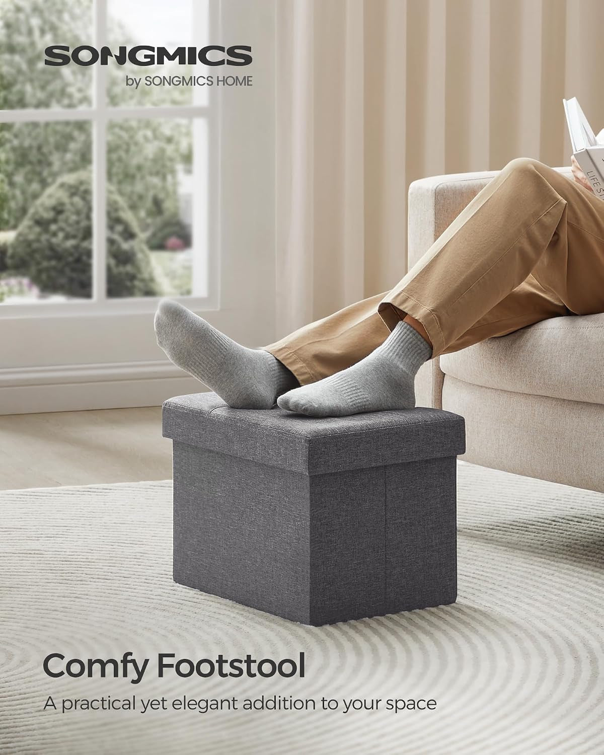 Person resting feet on closed dark gray ottoman used as a comfy footstool in a living room scene