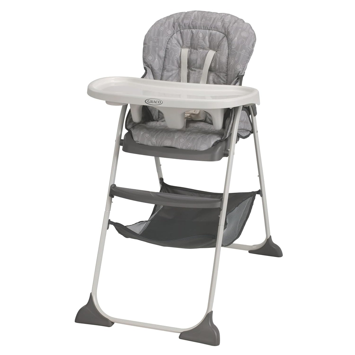Close front view of a gray patterned highchair showing tray, harness, footrest and under-seat storage hammock.