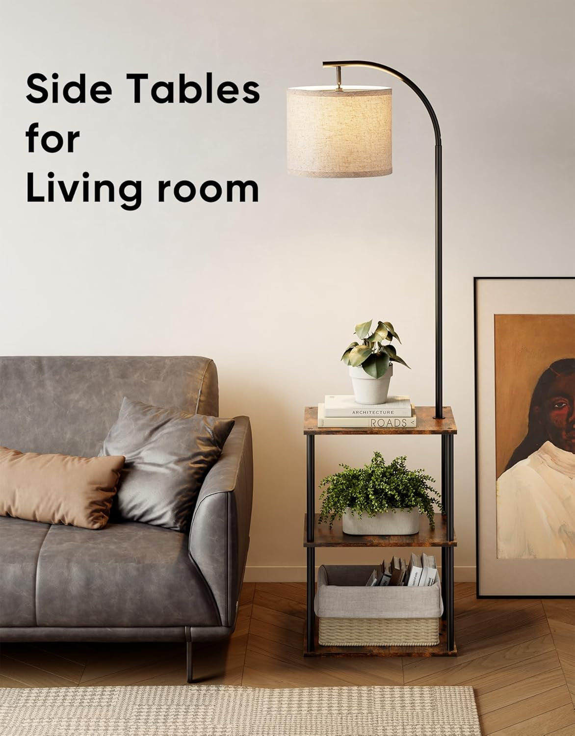 Arched metal floor lamp with drum shade integrated into a three-tier wood-and-metal side table holding books, plants and a