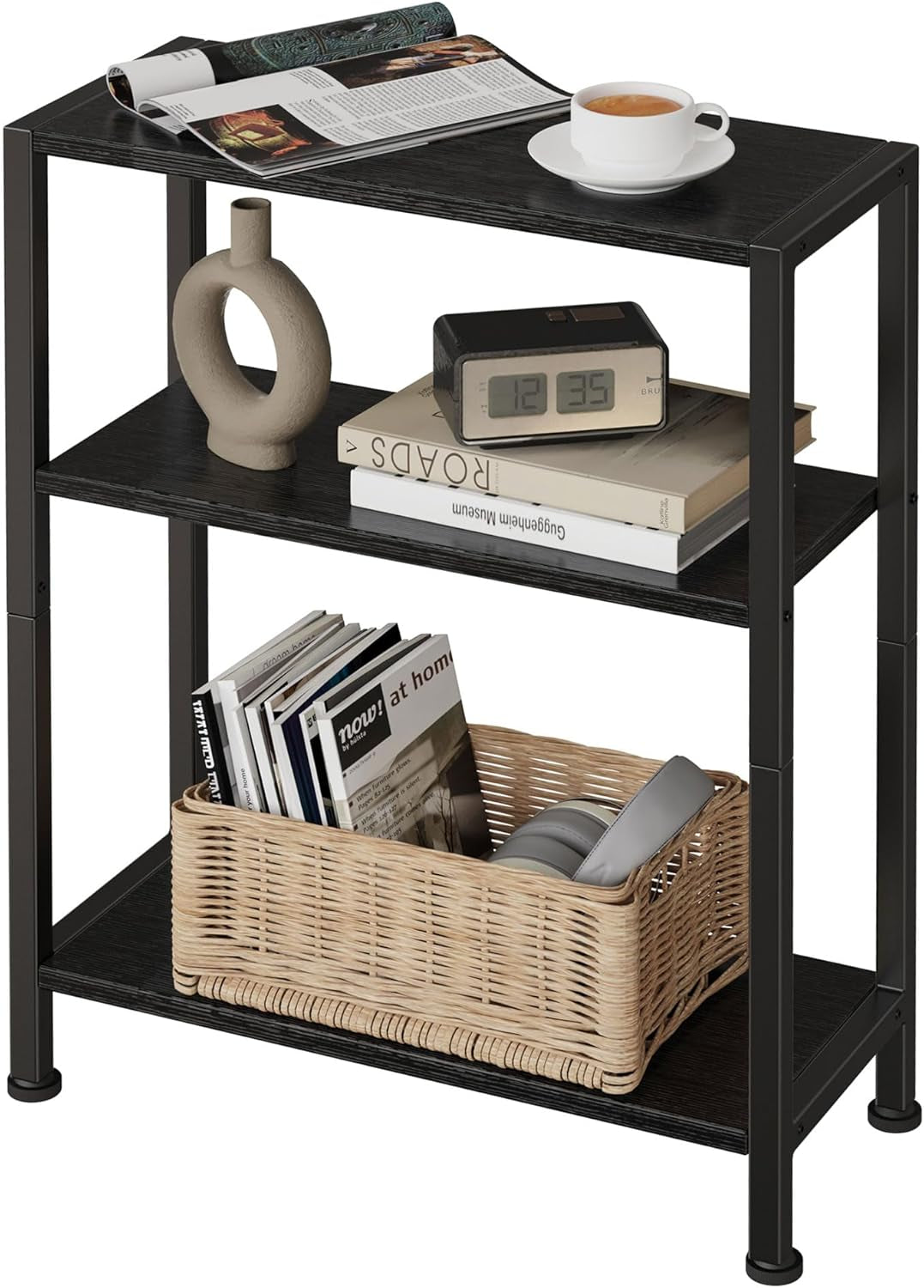 Three-tier narrow side table with black metal frame and dark wood shelves styled with a cup, clock, vase, books, and a