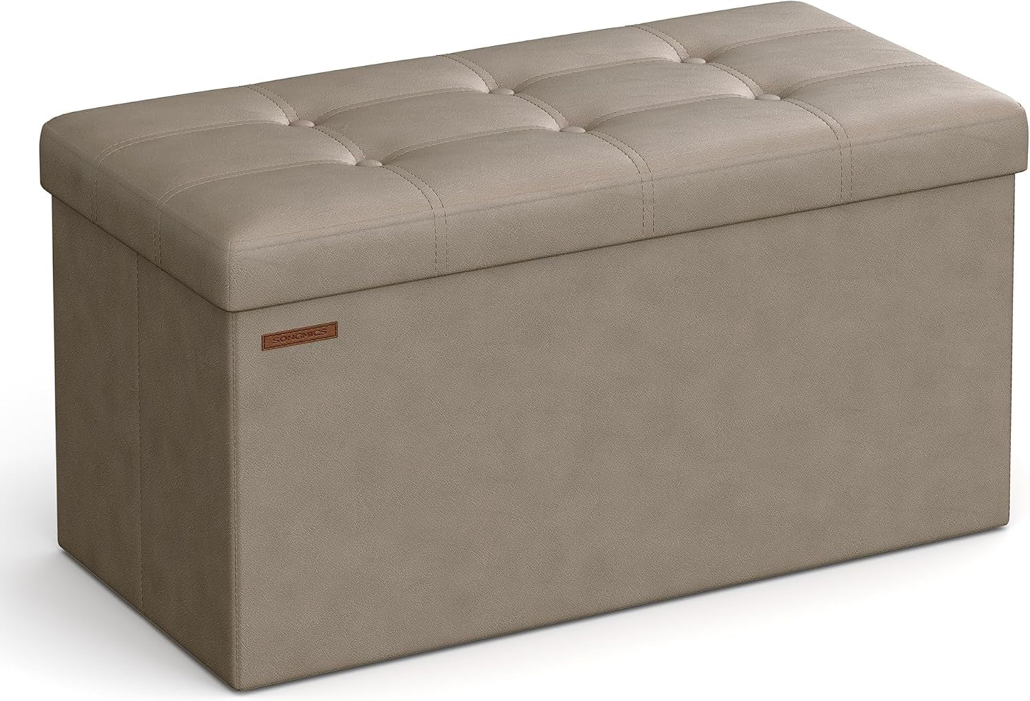 Three-quarter front view of a light taupe tufted faux-leather storage bench on white background.