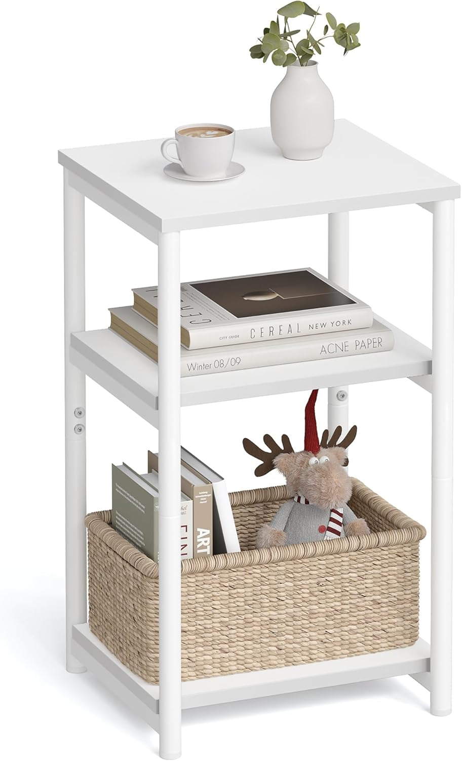 Three-tier white end table styled with books, a vase and a woven basket on the bottom shelf.