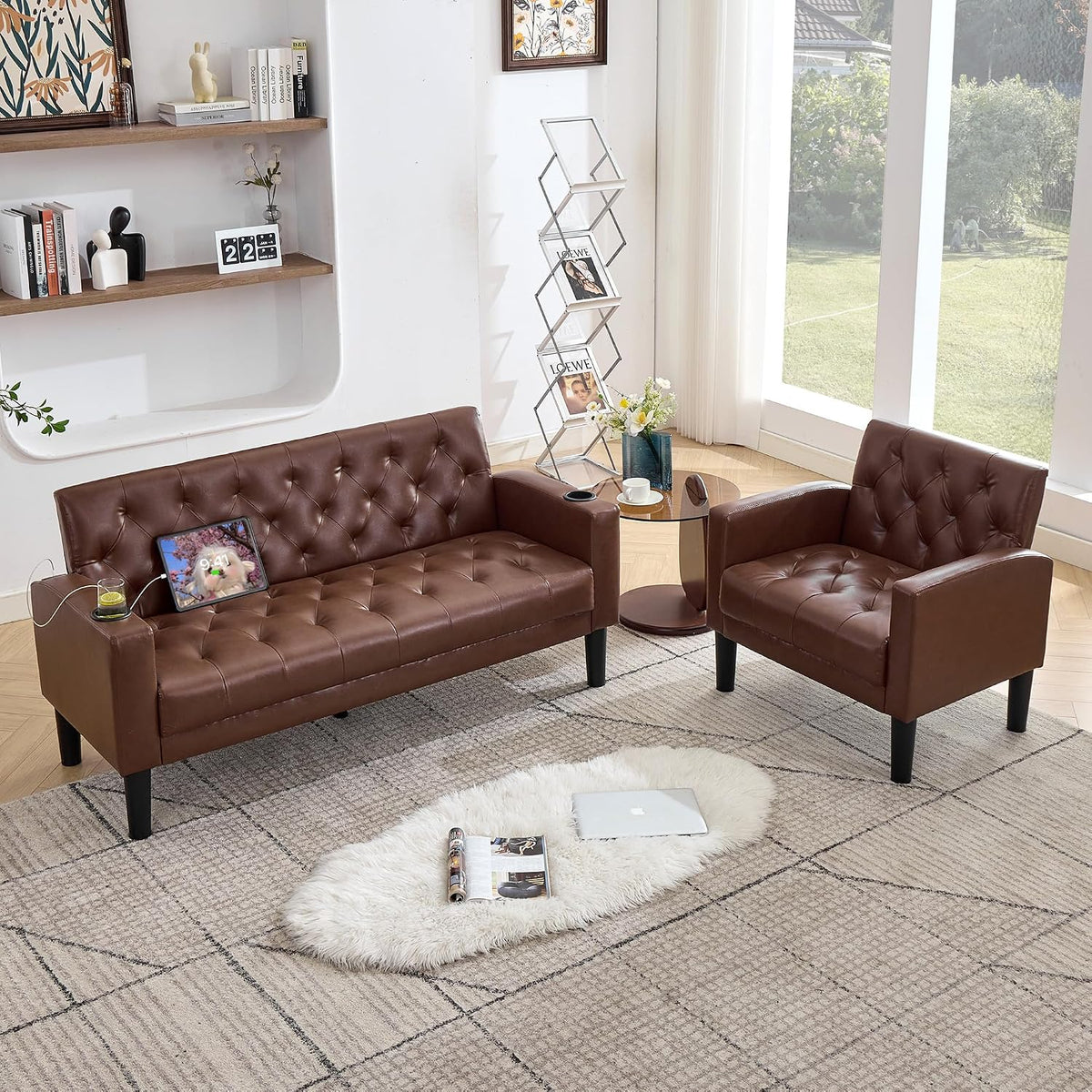 Brown tufted loveseat and chair set in a sunlit room, tablet resting on loveseat and shag rug foreground