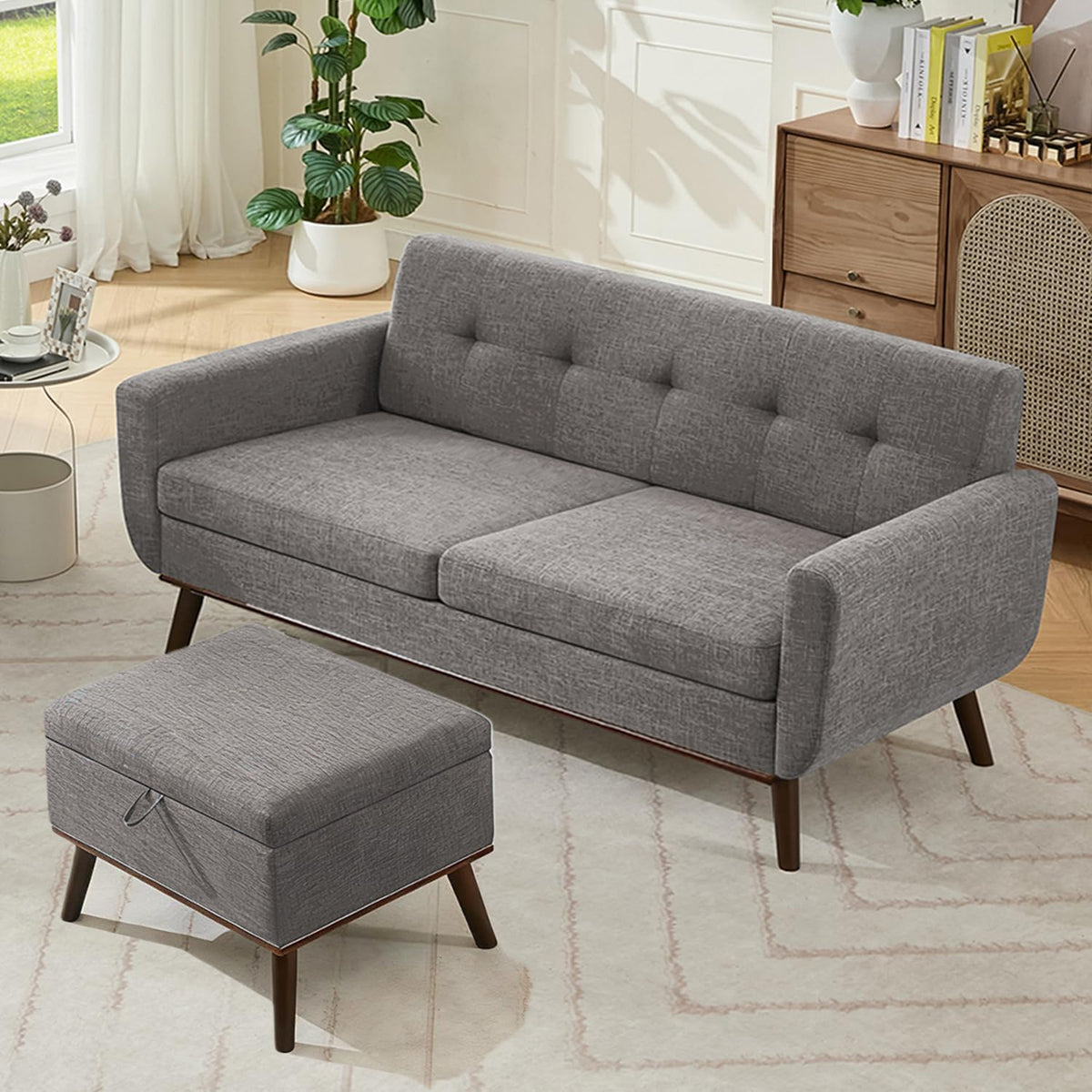 Gray tufted loveseat with matching ottoman on a patterned rug beside a wooden console