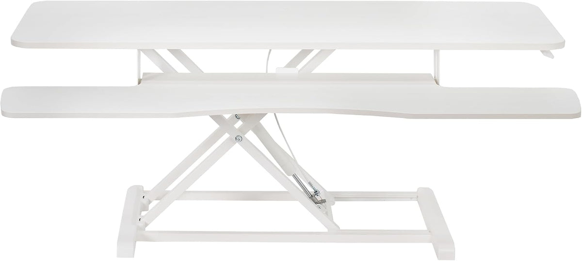 Straight front view of a white standing desk converter with raised top surface and curved keyboard shelf.