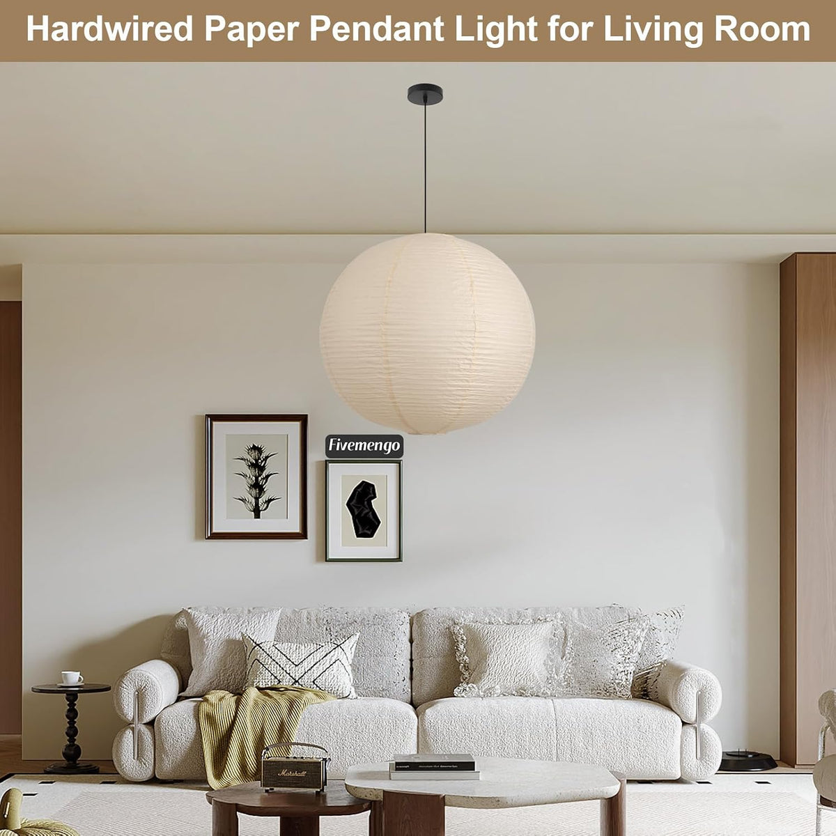 Off-white paper pendant light suspended in a living room above a sofa with wall art nearby