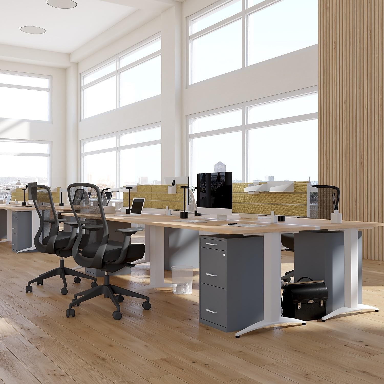 Open office scene with desks; a charcoal three-drawer mobile file cabinet sits under a shared workstation.