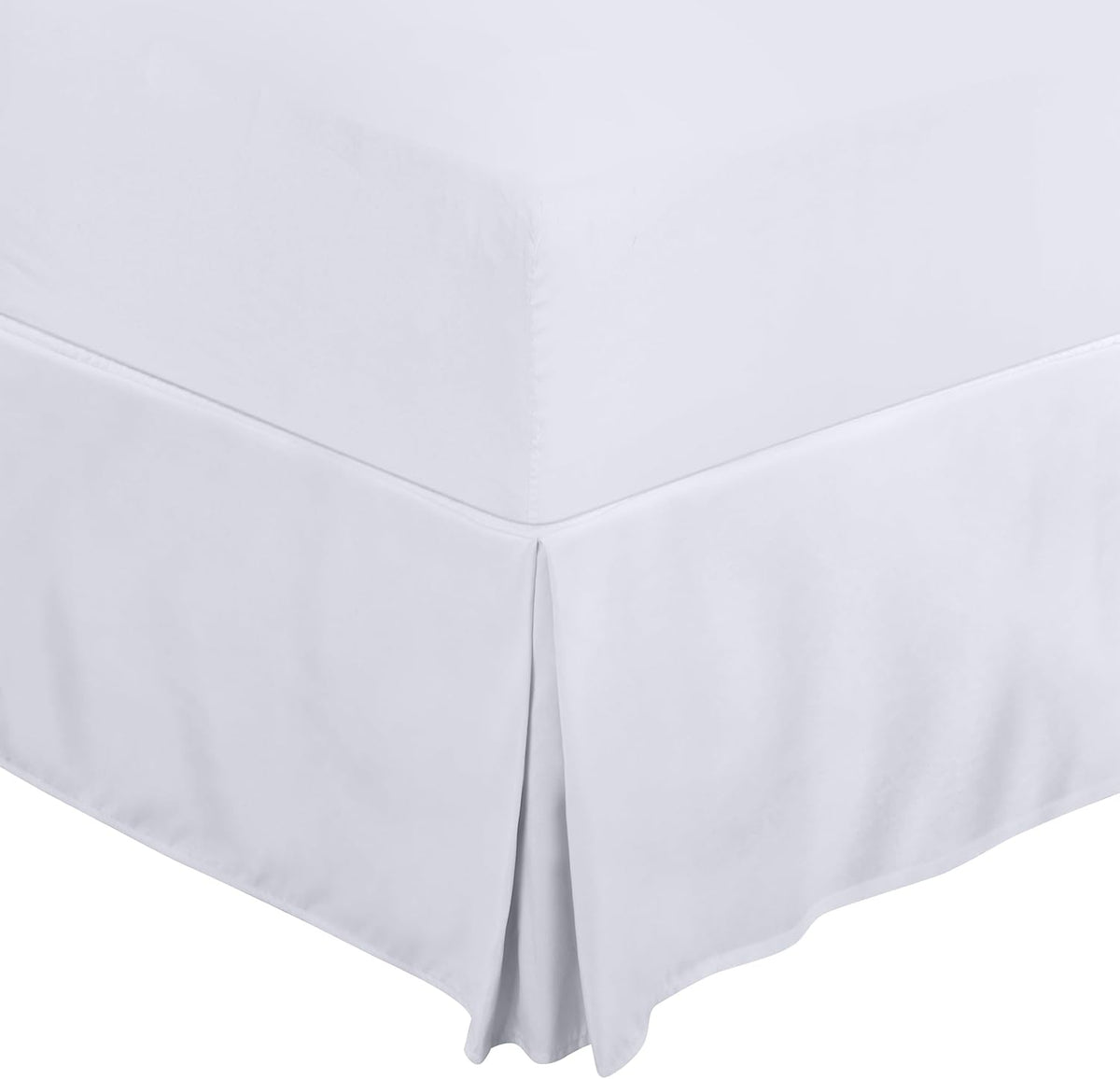 Close-up detail of a white pleated bed skirt at the mattress corner and pleat.