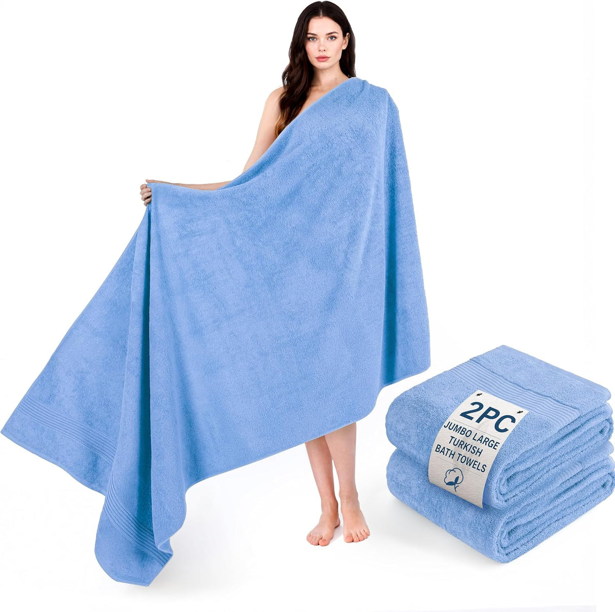 Model wrapped in a pale blue bath towel next to a neatly folded pair of matching light-blue towels