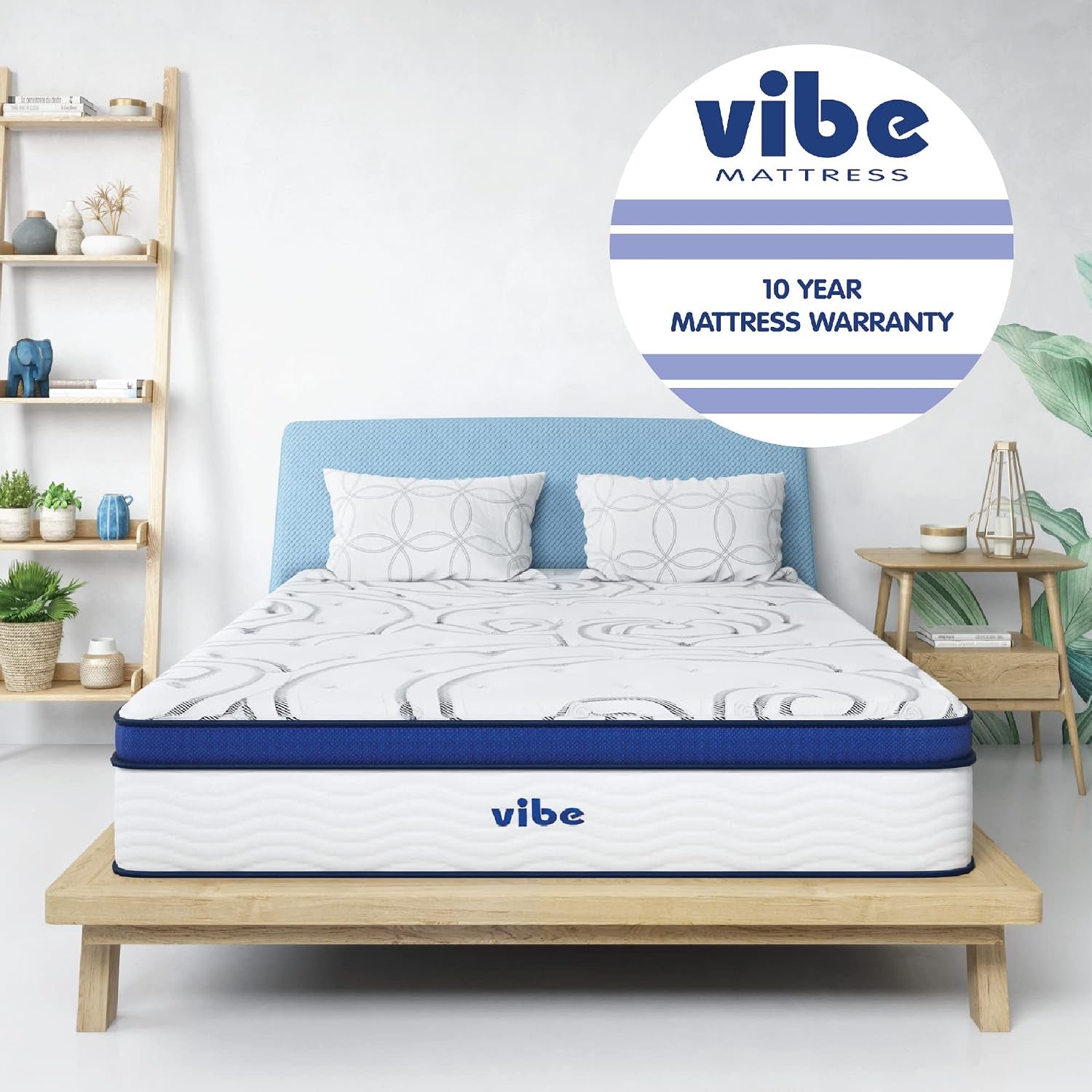 Bedroom scene with a white and blue mattress on a low wooden platform bed and a light blue headboard.
