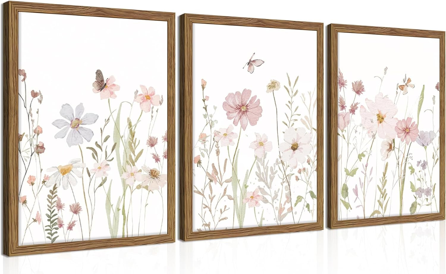Front perspective of three framed panels with soft pink watercolor wildflowers and wood-look frames, subtle floor