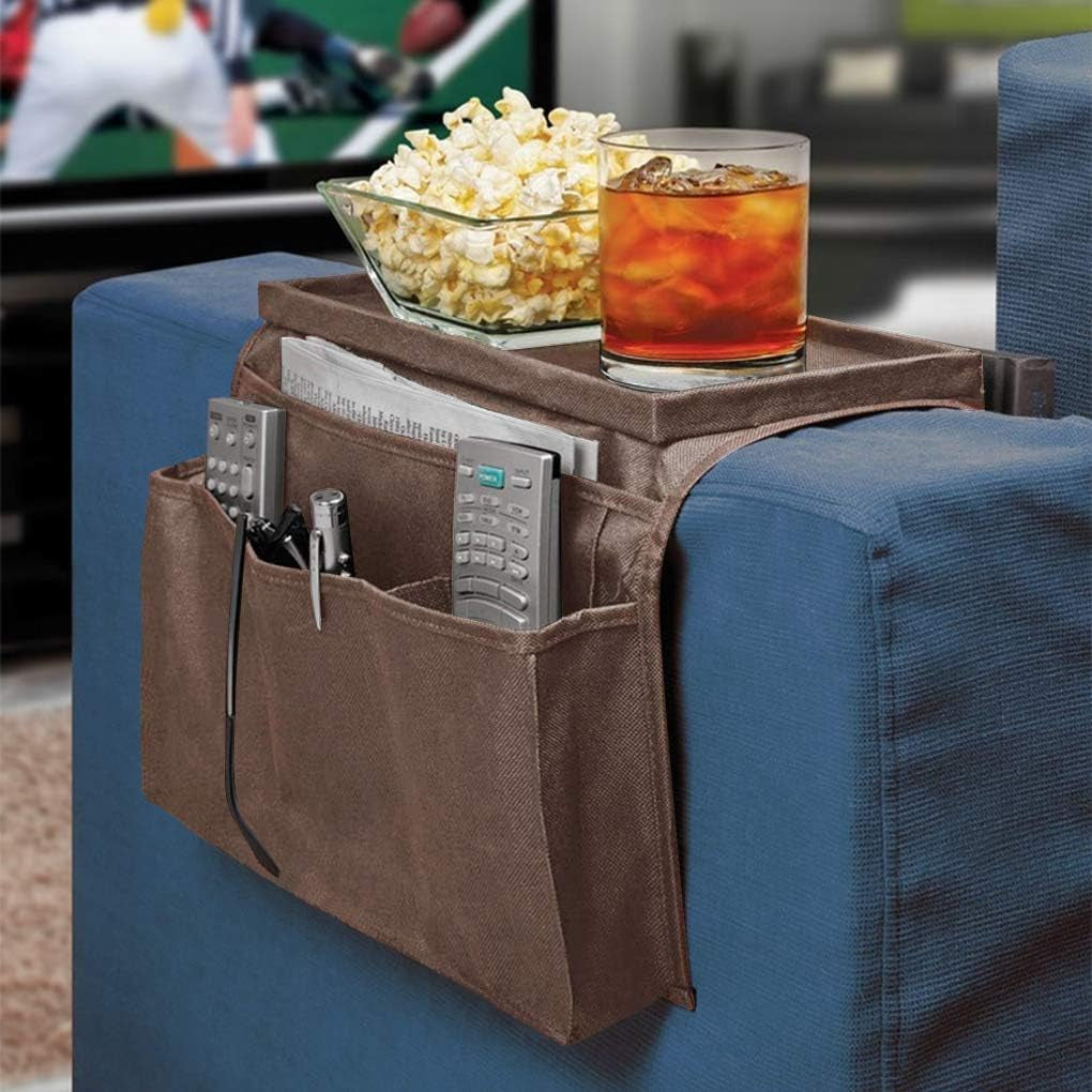 Brown armrest organizer on a blue couch arm holding remotes, papers and a drink on the top tray