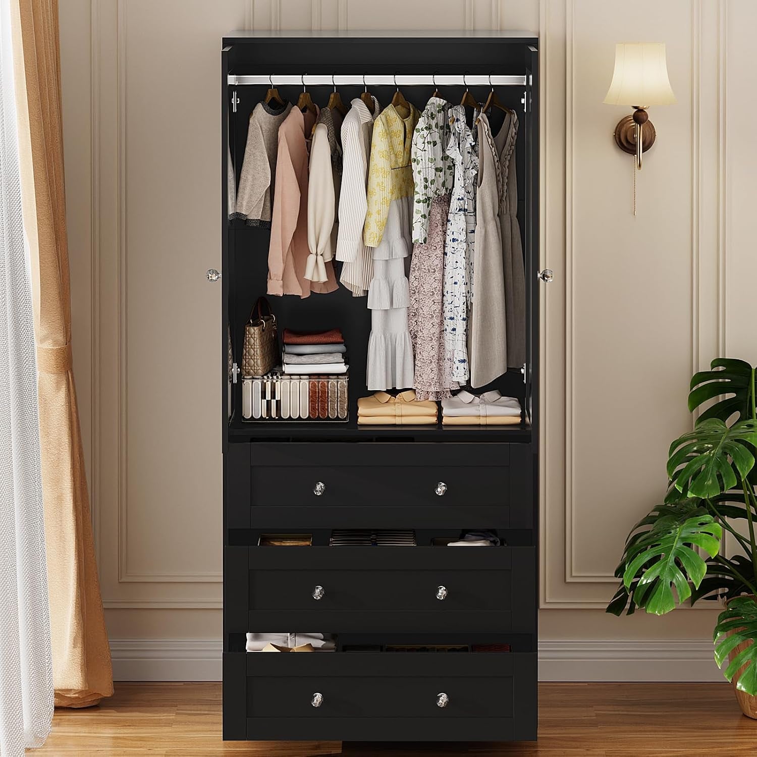 Front view of the open wardrobe showing hanging garments above and three drawers open below