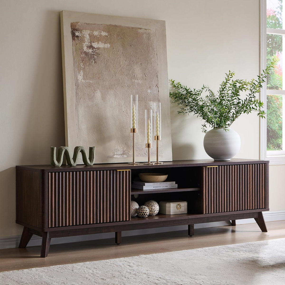 Dark walnut TV stand front view with decorative accents showing open center shelf and fluted doors