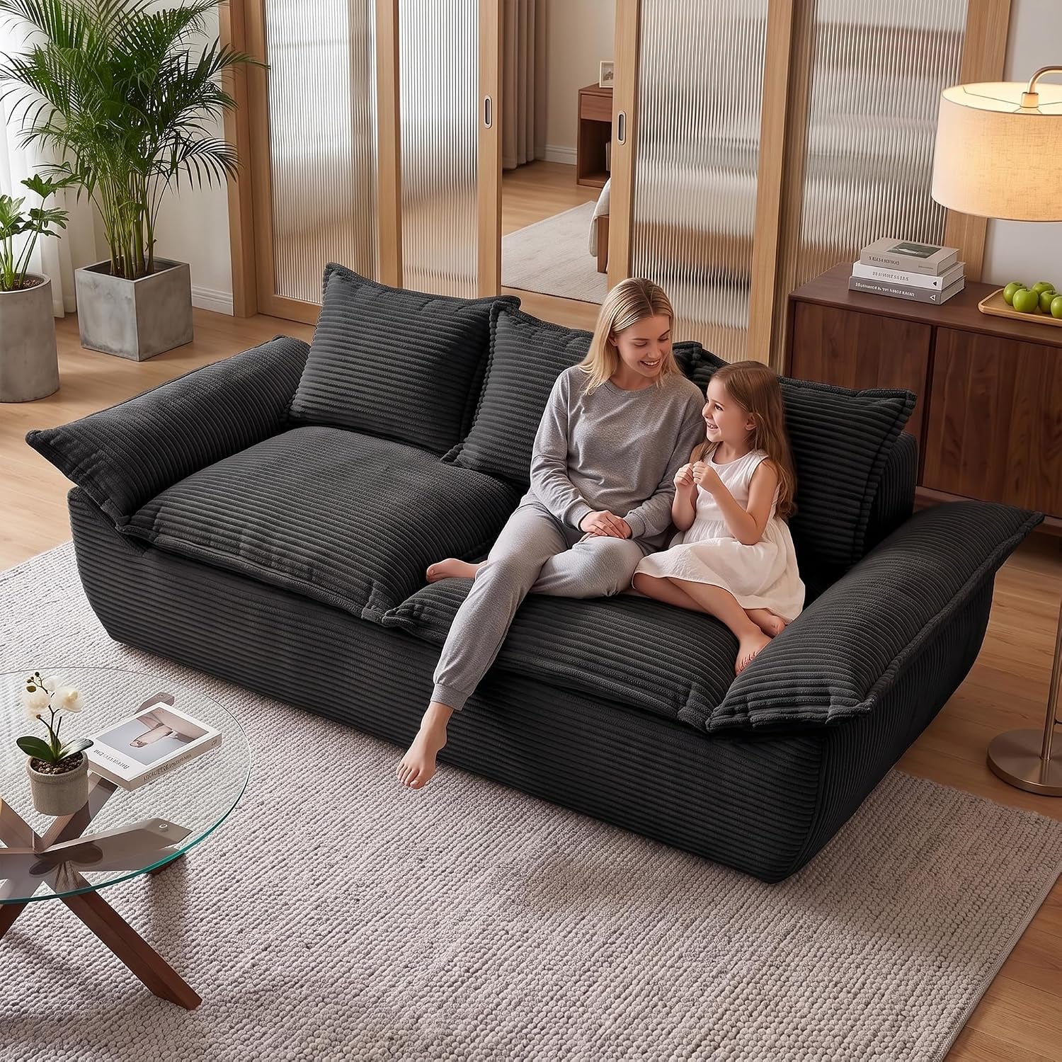 Dark charcoal corduroy sofa with a woman and child sitting and smiling together