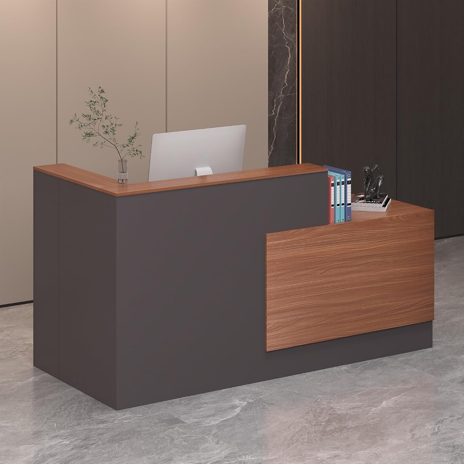 Angled view of an L-shaped reception desk with walnut top and slate-gray base, computer visible behind counter.