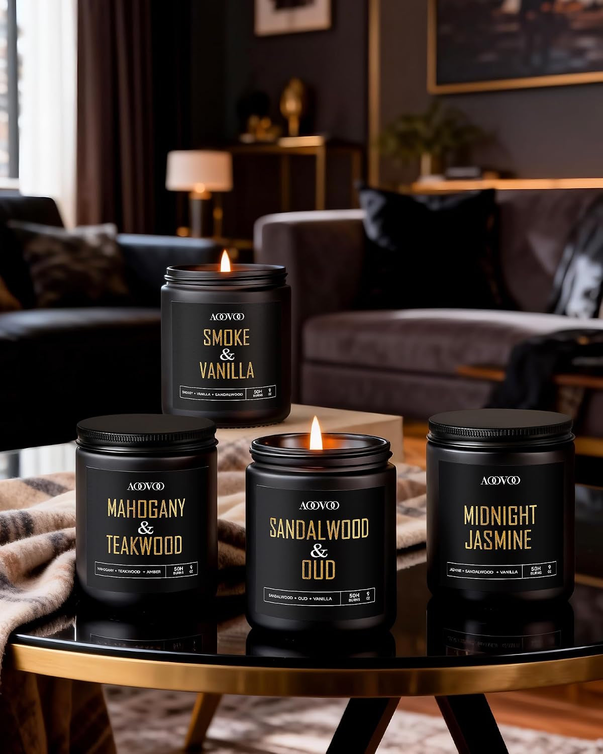Black jar candles displayed on a round glass coffee table in a living room setting with two candles lit.
