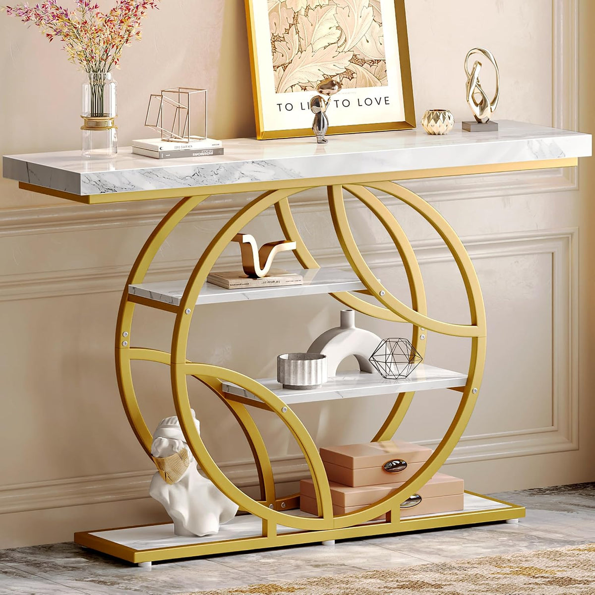 Close partial view of a gold circular metal frame console showing middle and lower shelves with decor.