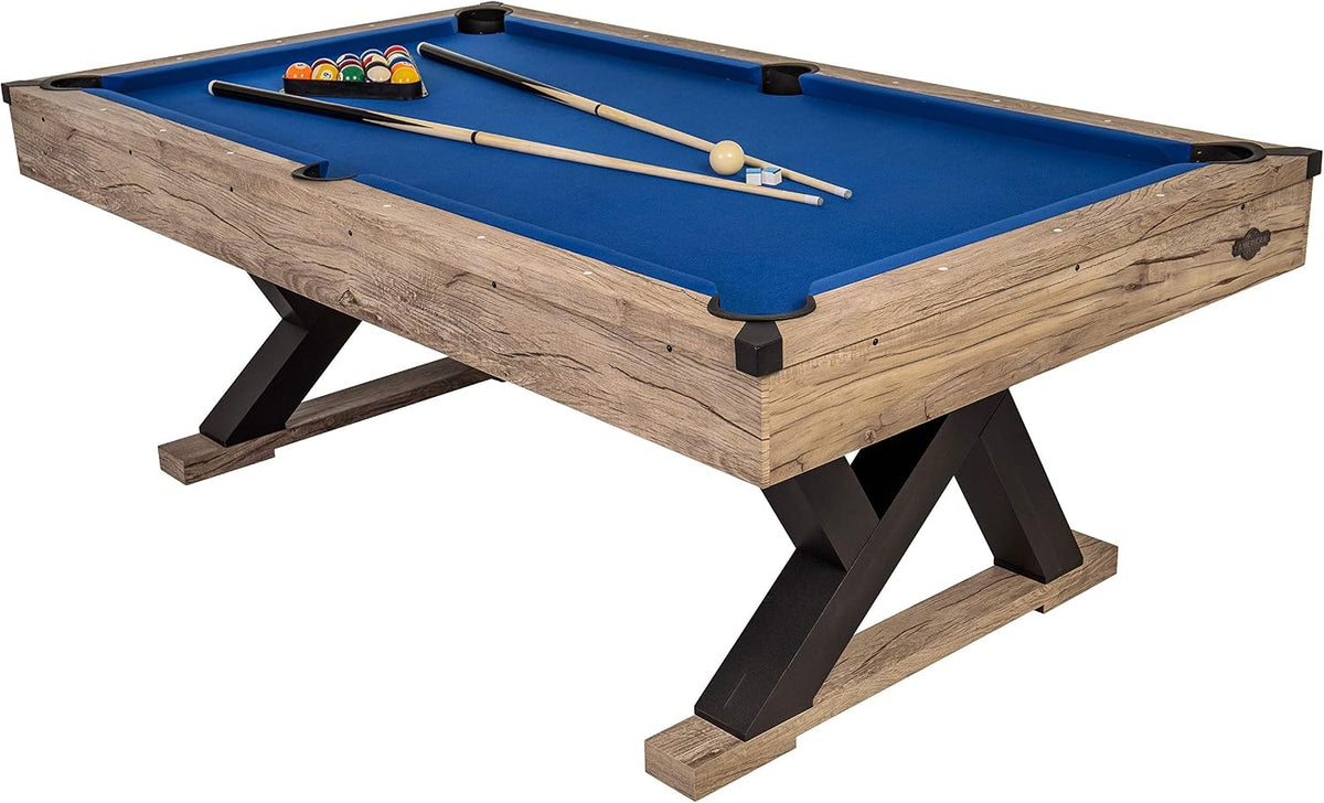 Three-quarter view of the billiard table showing X-shaped black legs and blue playing surface