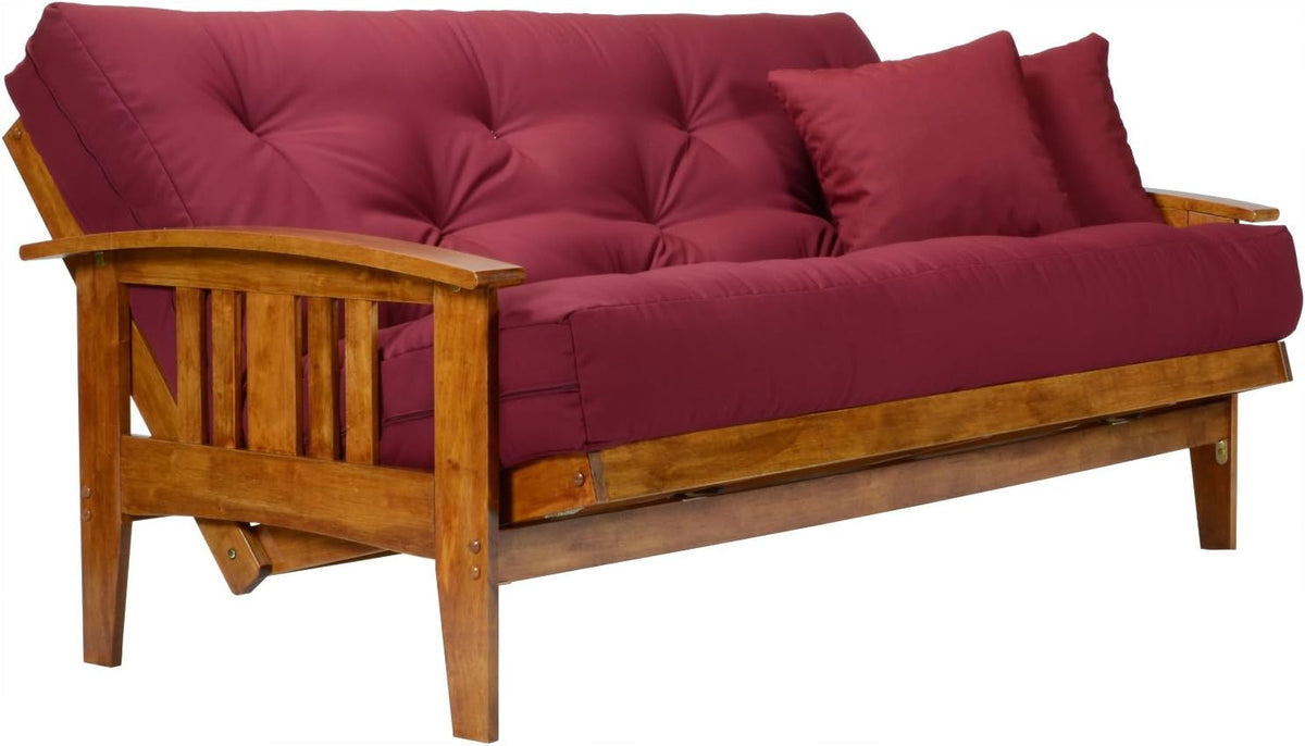 Tufted burgundy mattress on wooden futon frame angled side view highlighting slatted arm and legs