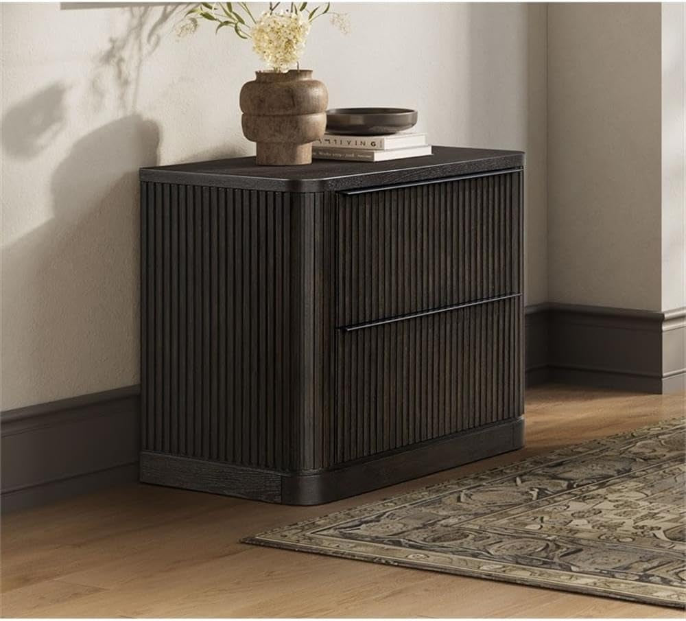 Brown two-drawer lateral file with fluted tambour detailing shown near a wall and rug in a room setting