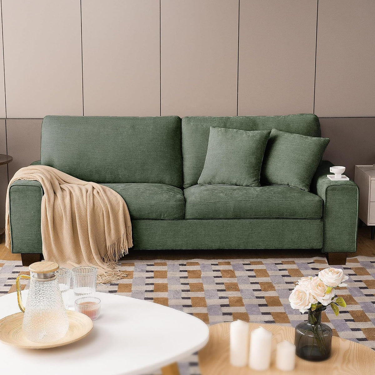 Front view of the loveseat in a muted green chenille, staged with a coffee table and rug in front.