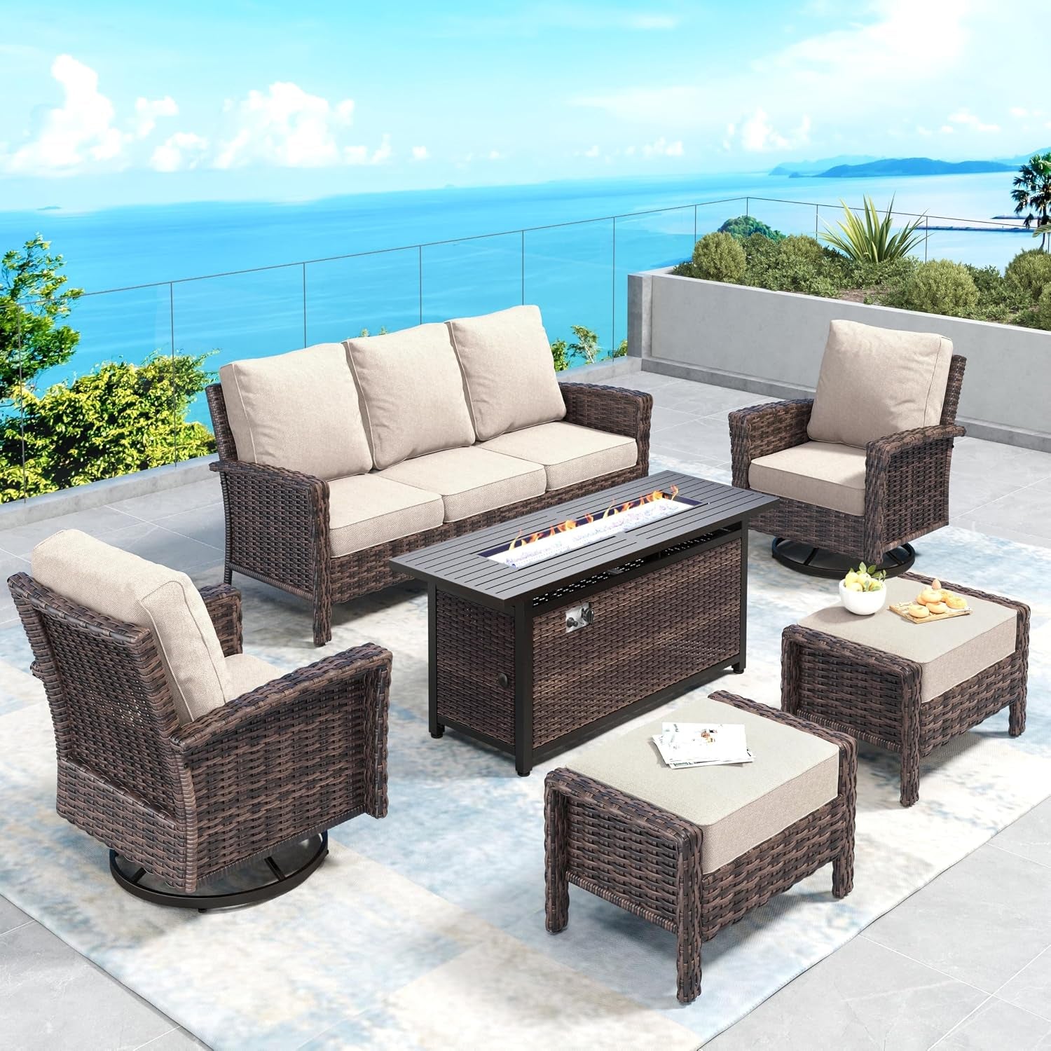Patio conversation set with three-seat sofa, swivel chair and ottomans around a rectangular fire table, beige cushions.