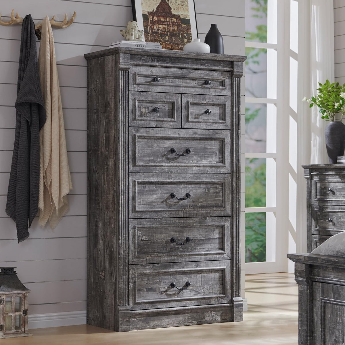 Tall rustic gray chest of drawers with fluted side columns and mixed metal hardware.