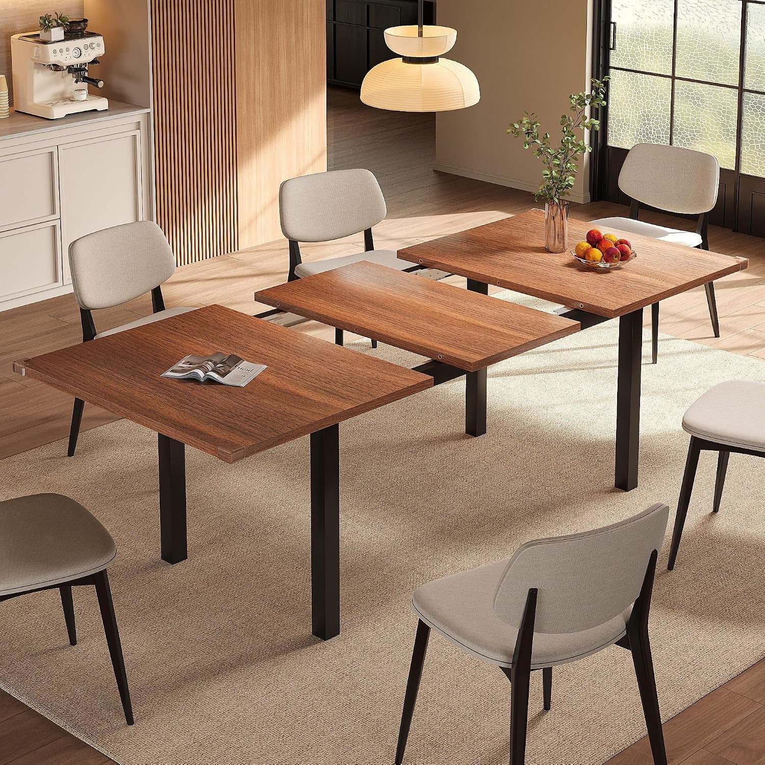 Walnut finish extendable dining table in staged dining room showing the middle leaf partially pulled out