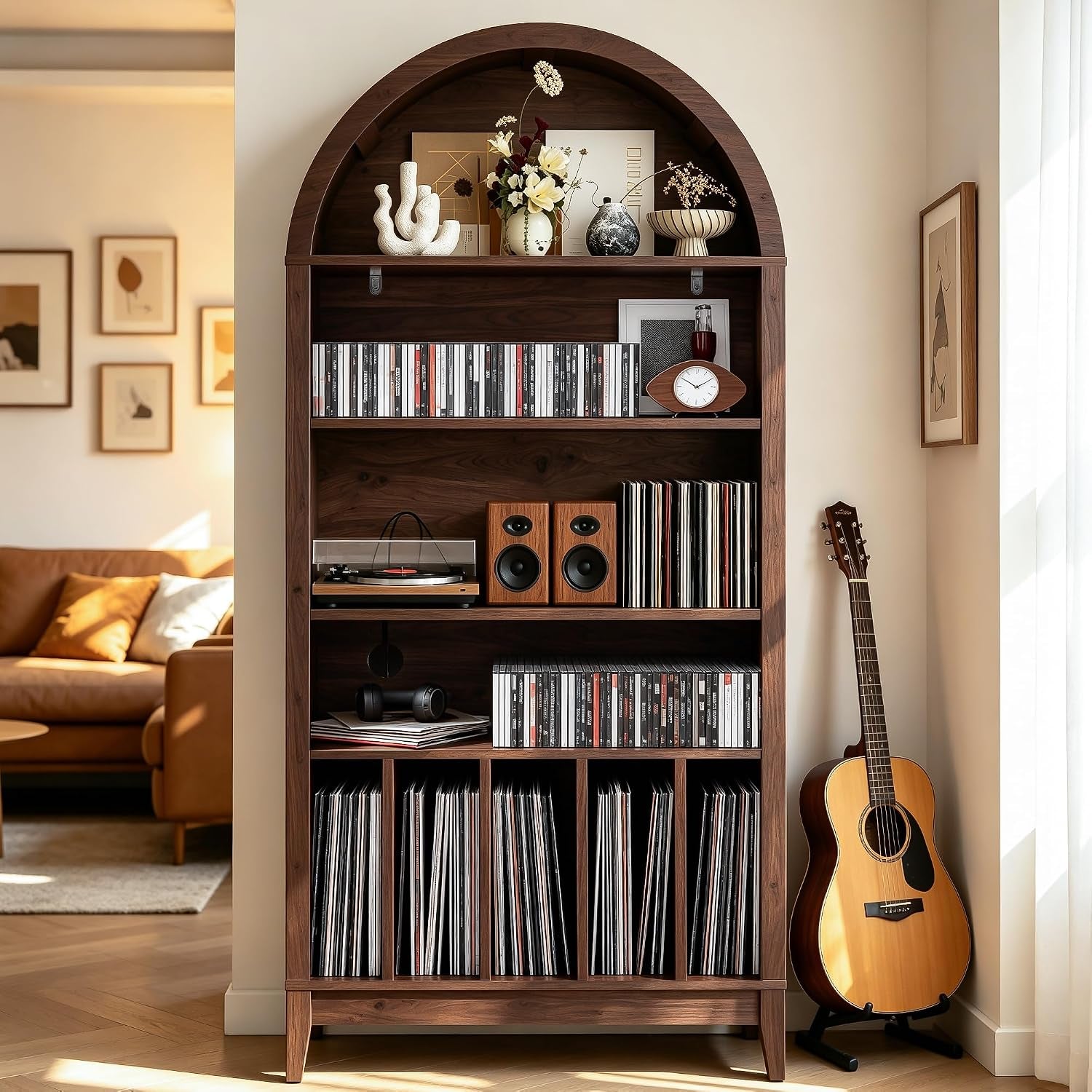 Straight front view of the walnut 5-tier record player stand filled with records, a turntable, speakers and decorative items