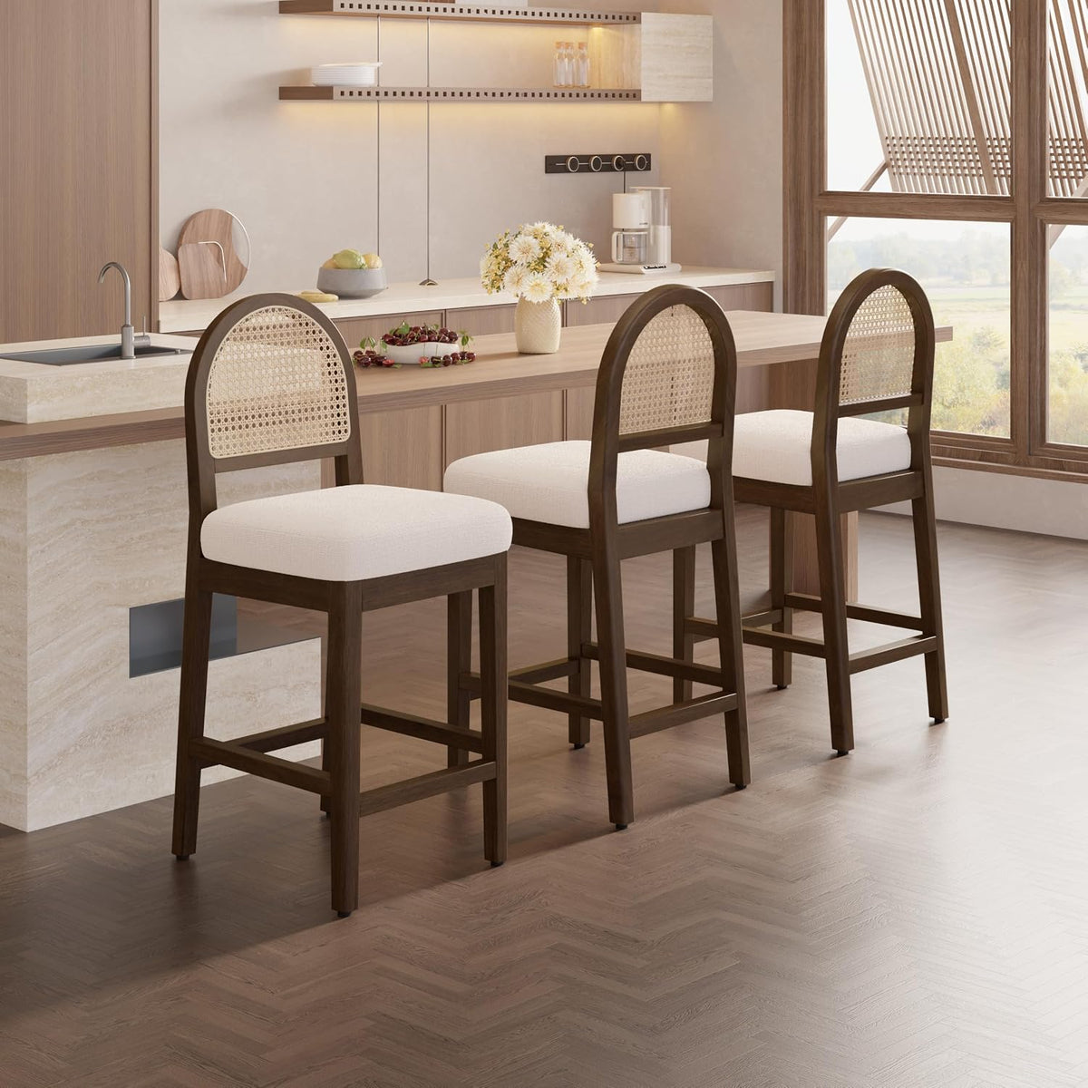 Three walnut finish stools shown from a side angle at a kitchen island with white chenille seats