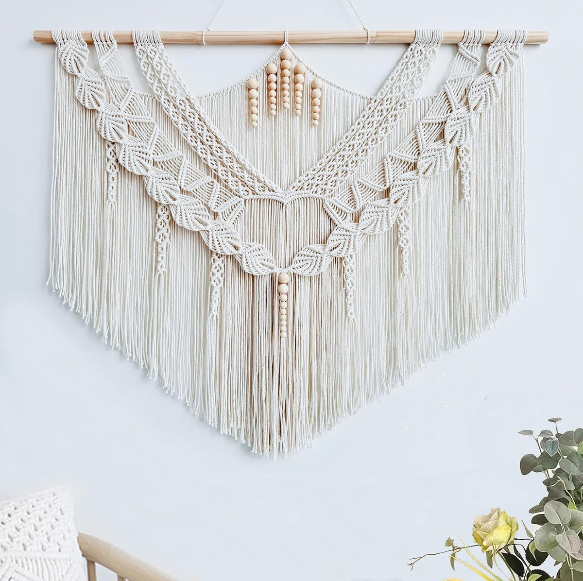 Cropped front view focusing on the central scalloped knotwork and vertical fringe with wooden bead tassels.