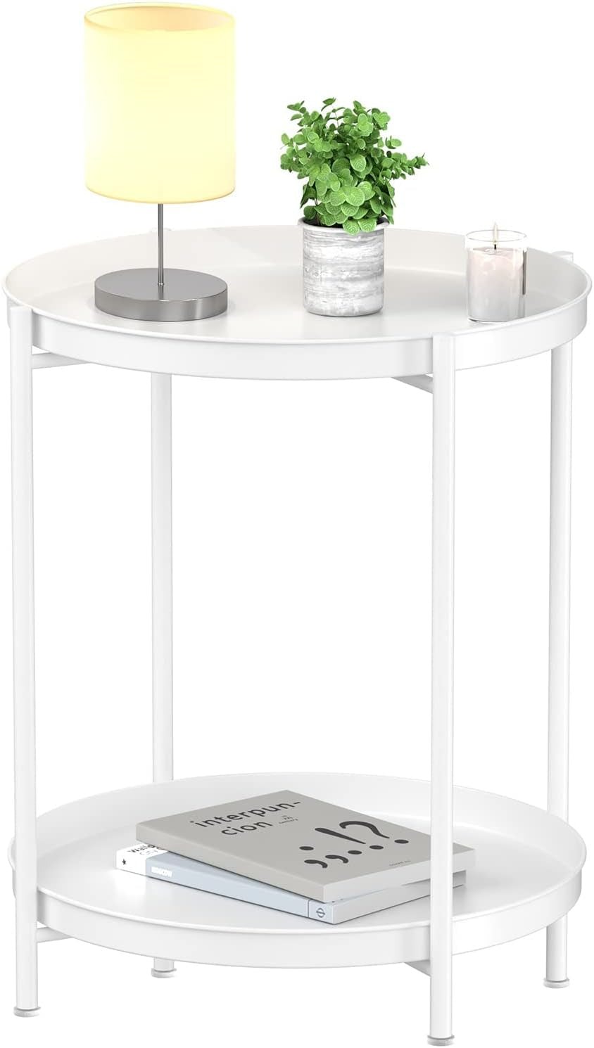 White two-tier round metal side table with lamp, plant and candle on top and books on lower shelf