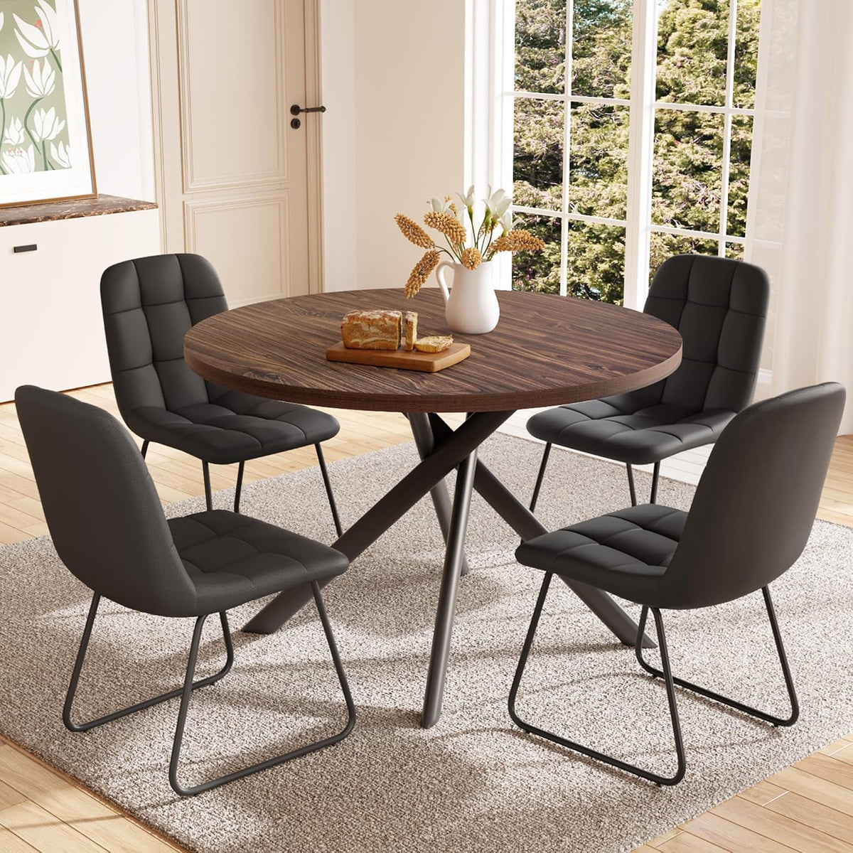 Walnut round dining table with four black PU chairs and a vase on the tabletop, front view in a dining room