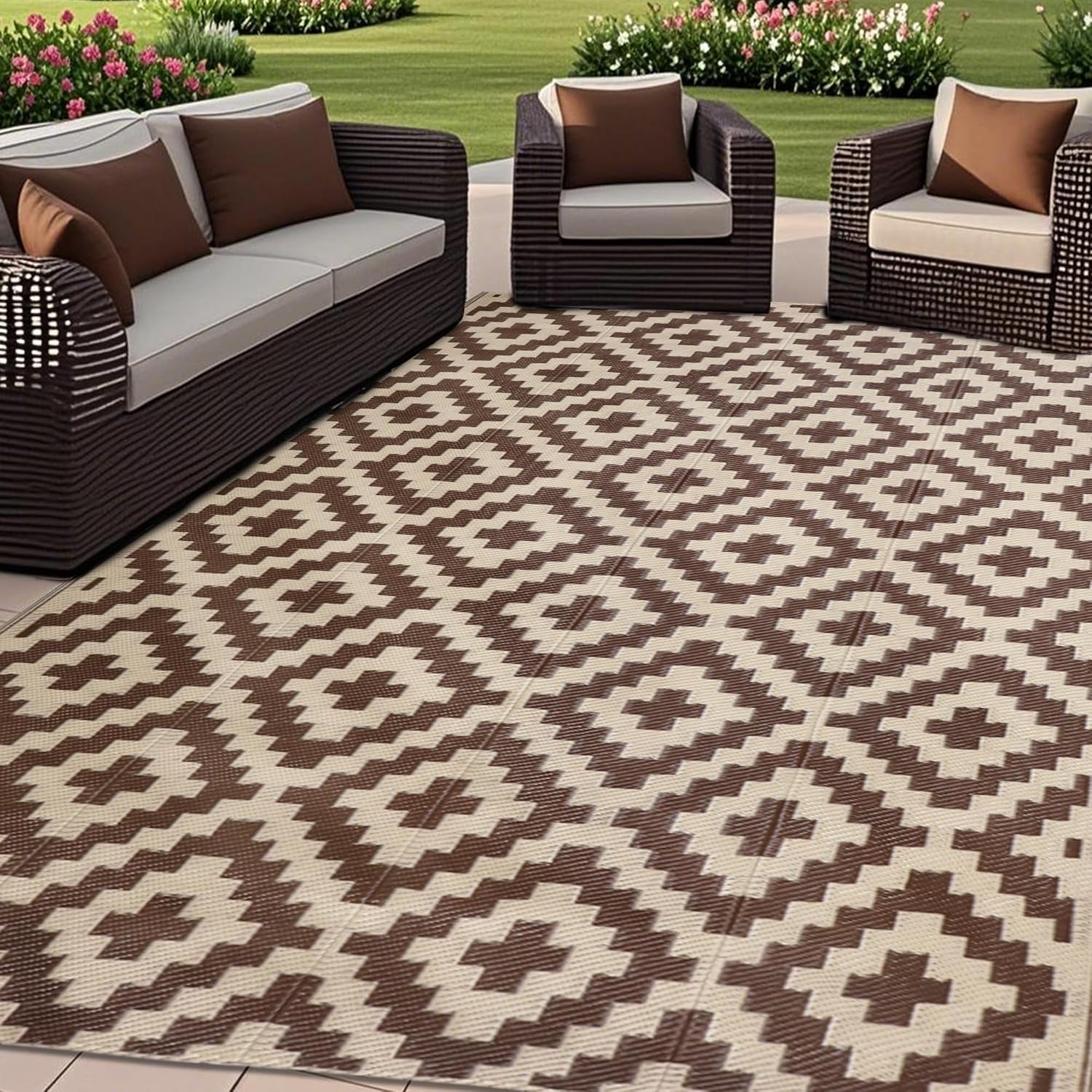 Patio seating arranged around a brown-and-cream patterned outdoor rug.