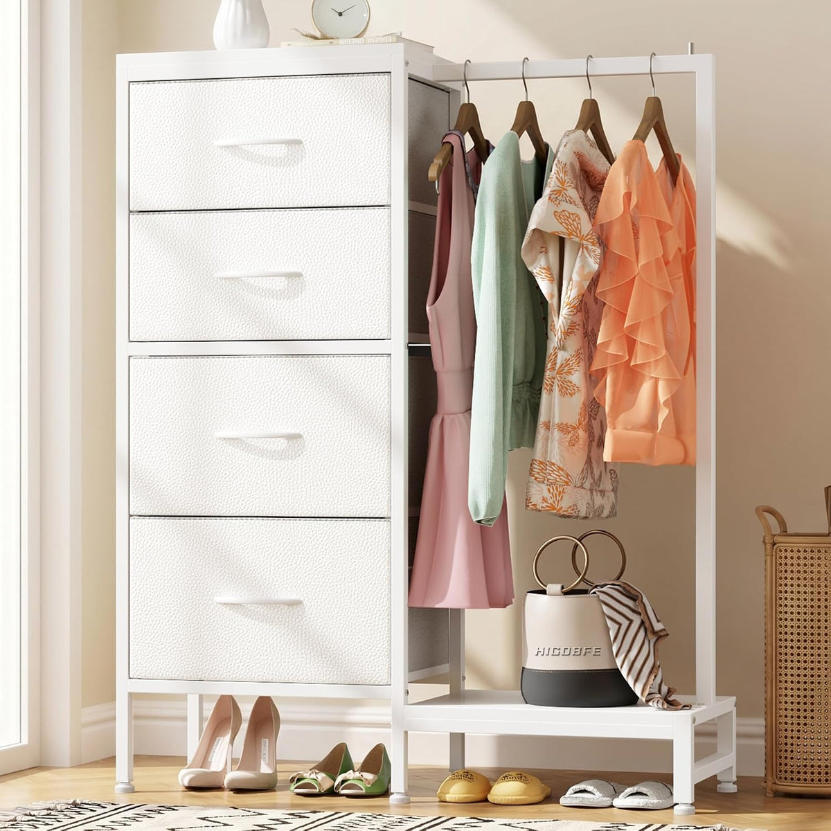 Close-up of white textured drawers beside hanging rail with dresses and a handbag on the lower shelf.