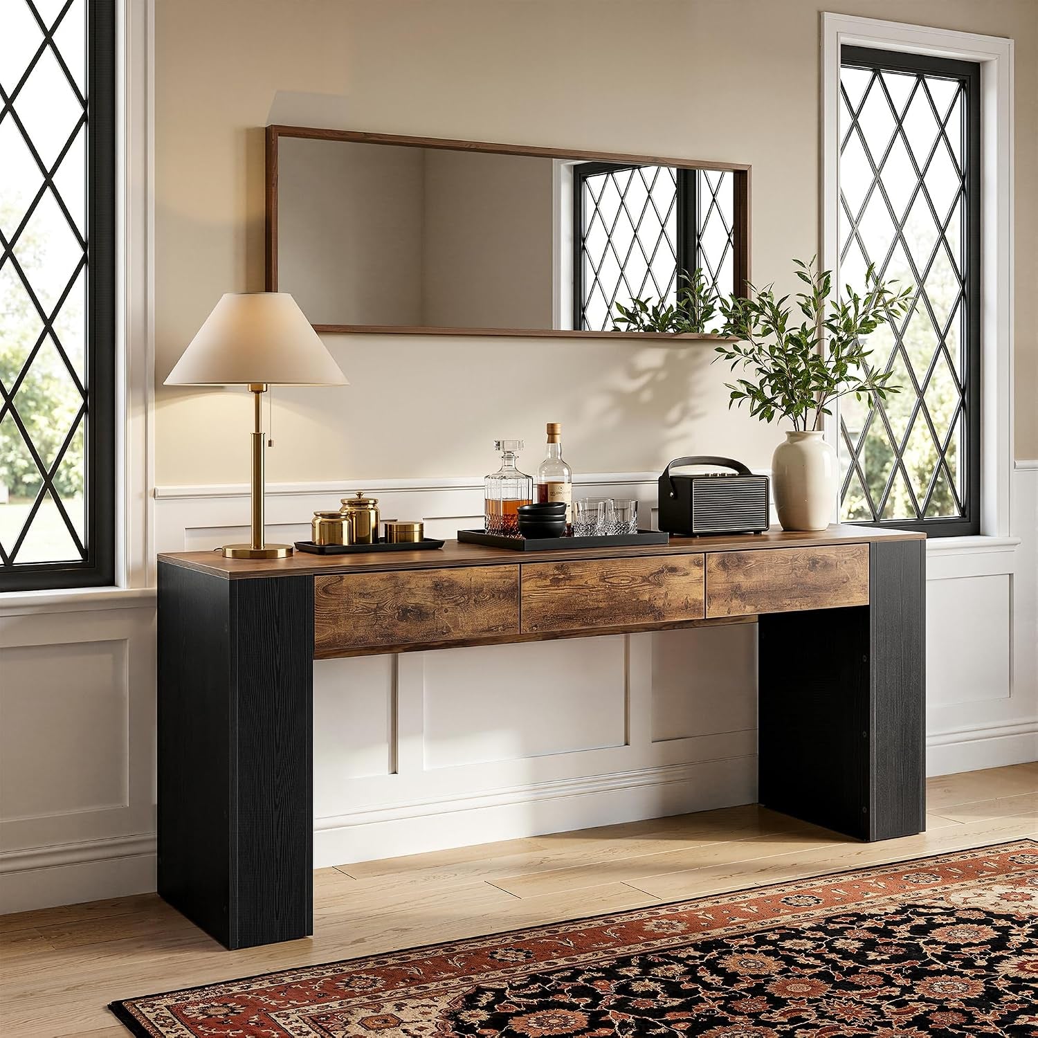Rustic brown and black console table front view staged in an entryway with mirror, lamp, and decor