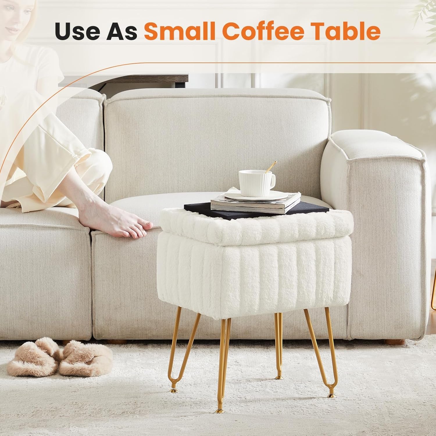 White faux-fur square ottoman with gold metal hairpin legs used as a small coffee table beside a beige sofa.